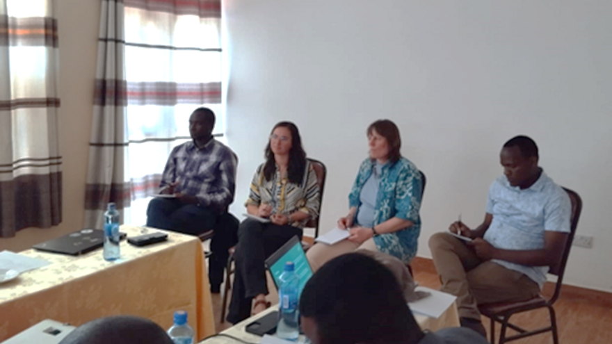 Four people seated as a panel