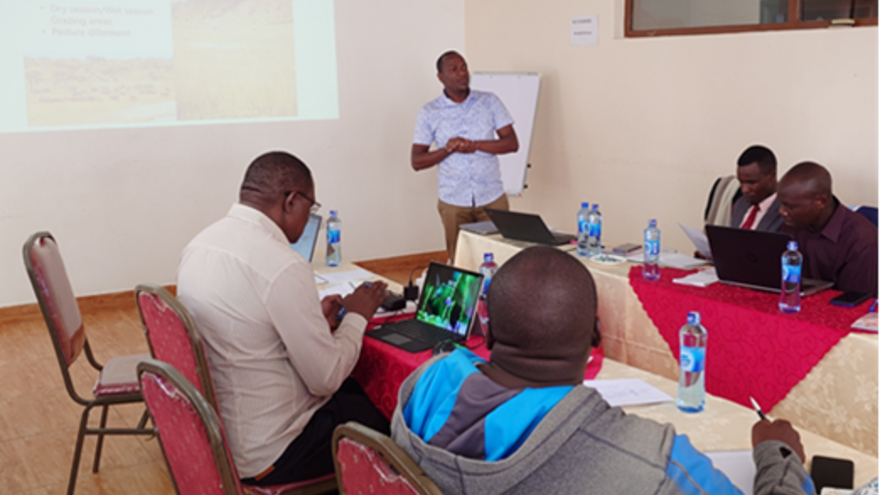 Mr Munda presenting on the state of climate change in Laikipia in front of a seated audience