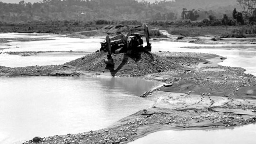 Two excavators, used in gold mining, moved to the highest point of the river bed after a major, sudden flood in southeast Ecuador.