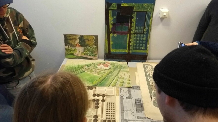 Historical drawings give the students more vocabularies to interpret the site and to present their own projects in future (pictures: students watching historical drawings).