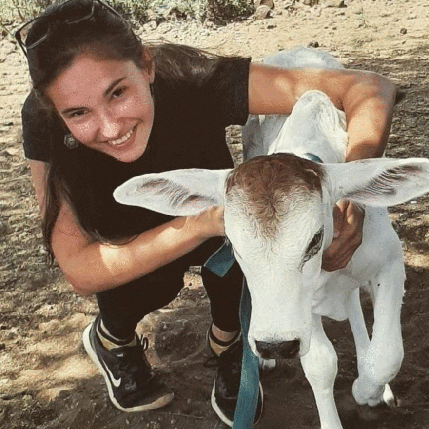 NMBU researcher Edwige Marty with a calf whilst researching climate change adaptation by pastoralist cattle farmers in Kenya.