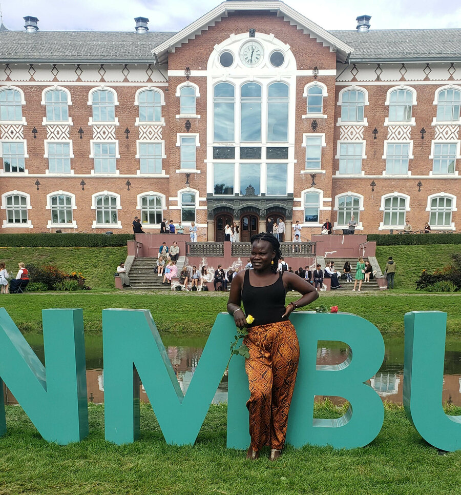 Noragric Master student Jane Lakot on the lawn outside NMBU's iconic Clock Building. 