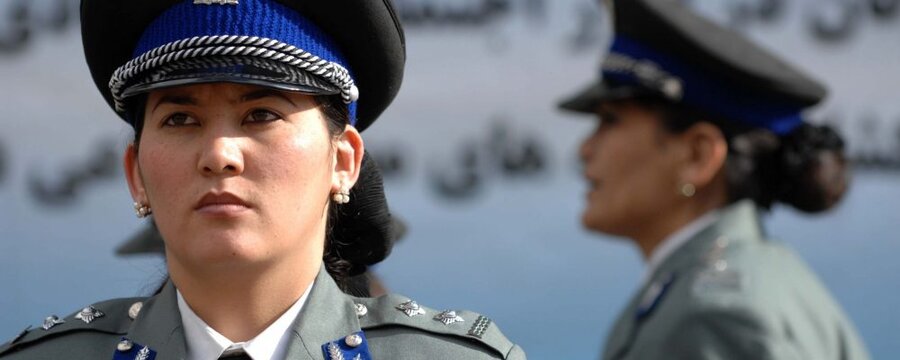 An Afghan National Policewoman stands to attention before the start of the International Women’s Day ceremony at the Ministry of Interior in Kabul, Afghanistan (4 March 2010). 