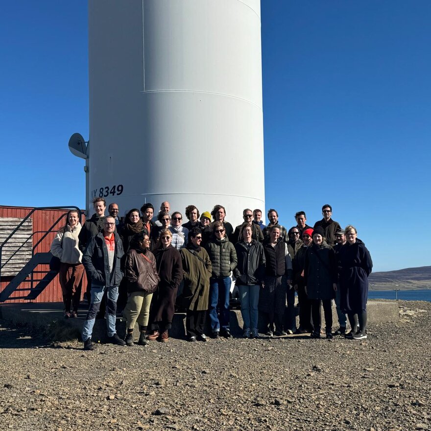 Empowered Futures research school members under a wind turbine at Burgar Hill, Orkney