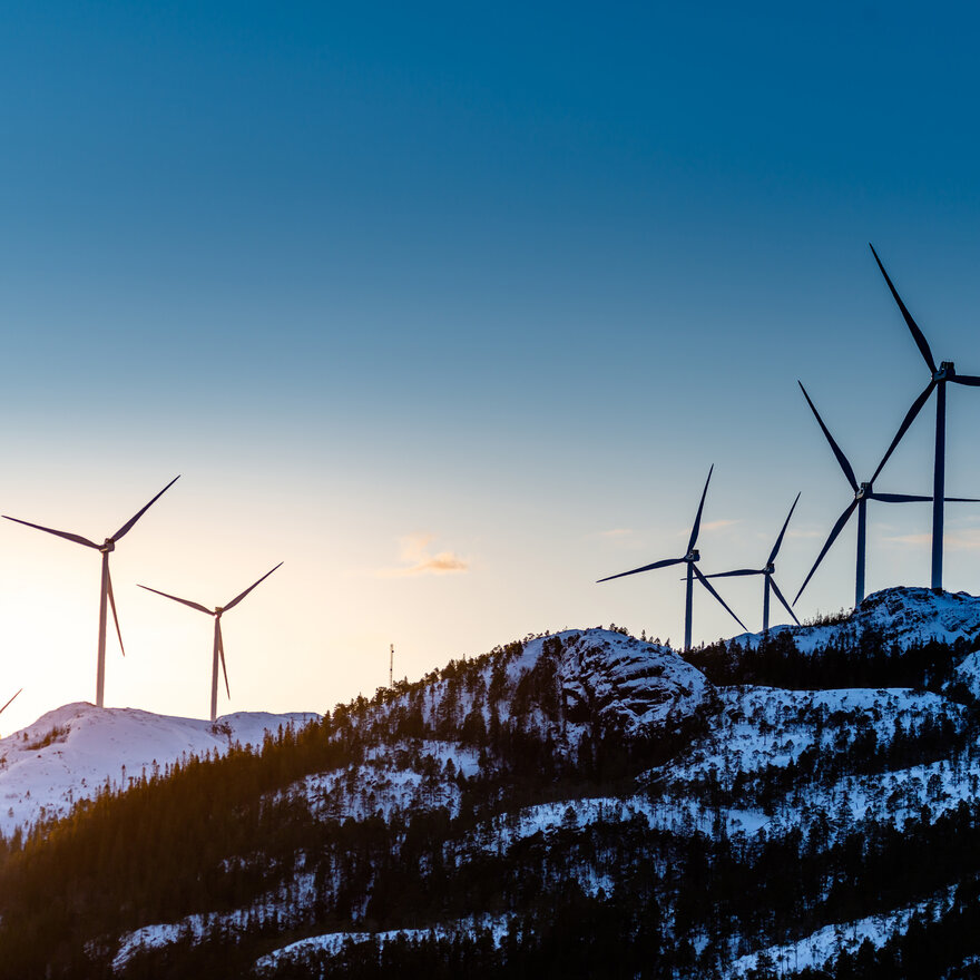 Wind turbines over a mountain in Fosen, Norway. 